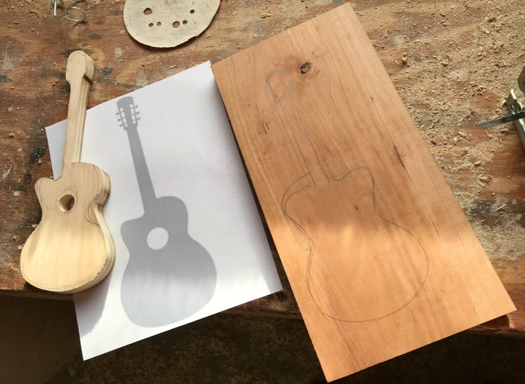 Scrap wood guitar template traced to cut