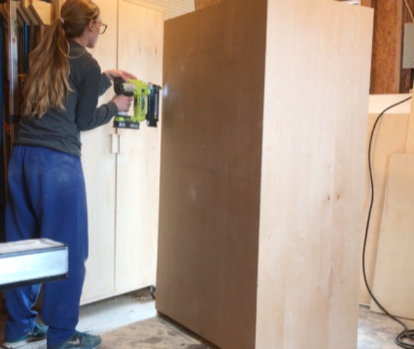 Shara Woodshop Diaries installing back panel onto storage wardrobe cabinet box