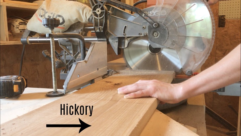 trimming hickory wood to length on miter saw