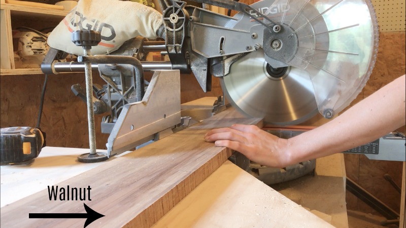 trimming walnut board to length on miter saw