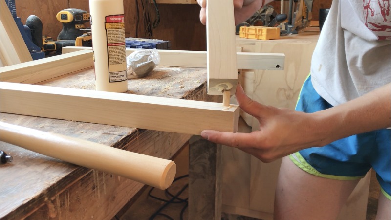 Insert dowel into dowel holes on joining pieces of wood to build nightstand frame