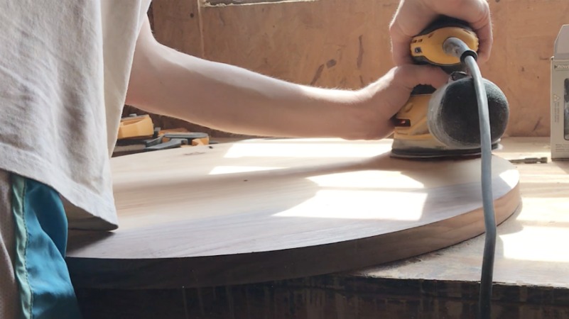 Shara Woodshop Diaries sanding round wood plate to use as a clock