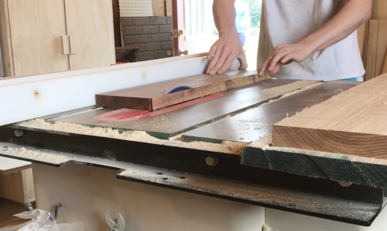 trimming edge of walnut board on table saw