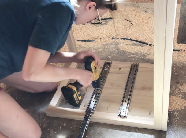 Screw drawer slides onto body of diy modern nightstand