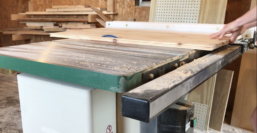 Trim DIY wooden stove top cover to correct size on table saw