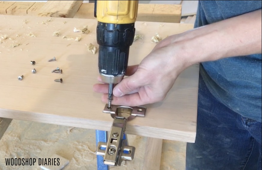 Using drill to drive small screws into door hinges