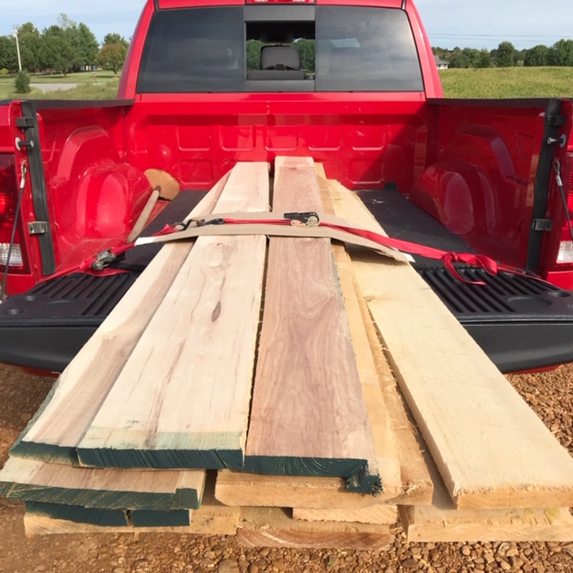 hardwood lumber stacked and strapped down in truck