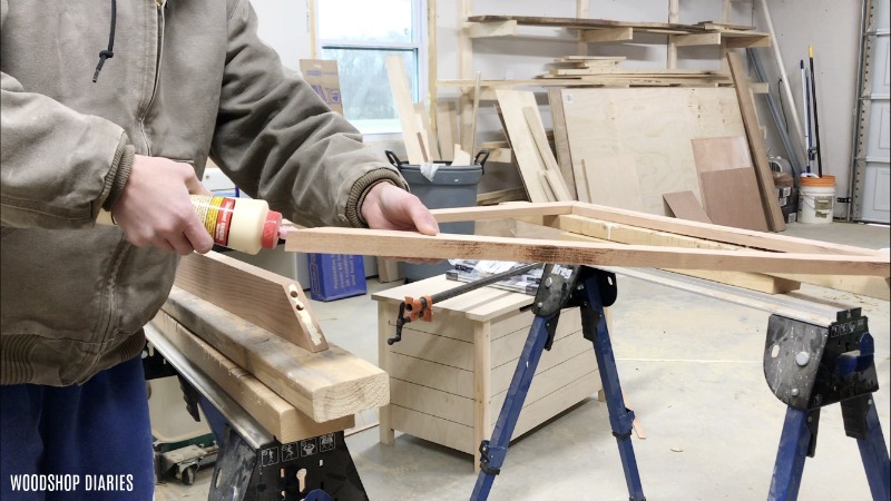 Applying wood glue to mitered joints on picture frame made with dowels