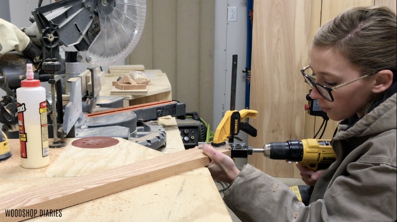 Shara Woodshop Diaries drilling dowel holes into mitered corners to assemble