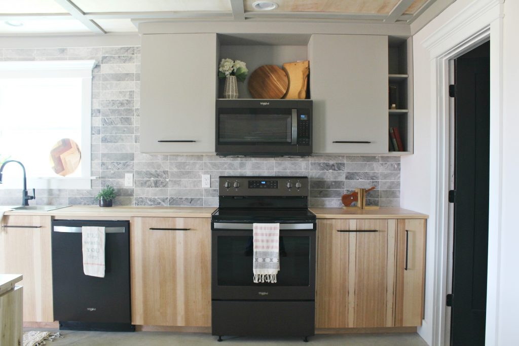 Modern kitchen cabinets installed with black stainless appliances