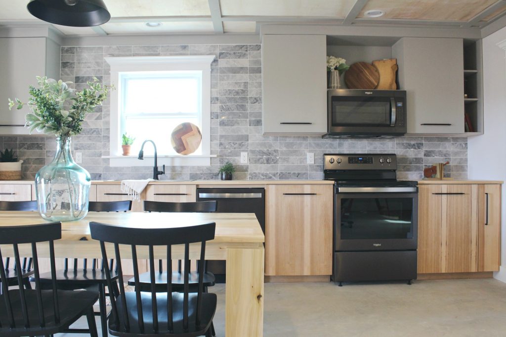 Modern kitchen cabinets installed into gray and wood kitchen