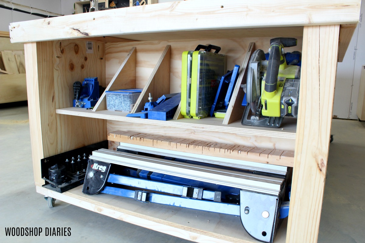 End of workbench storage cubby with divider panels for tools and jigs