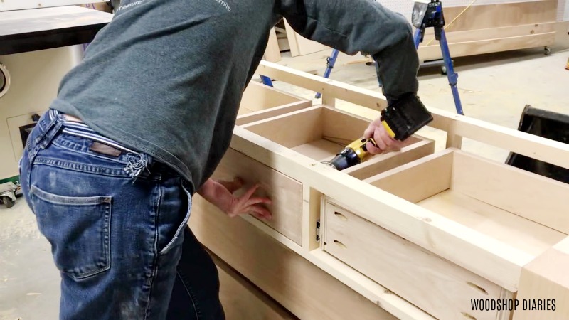 Installing drawer box fronts by screwing in from the front of drawer box