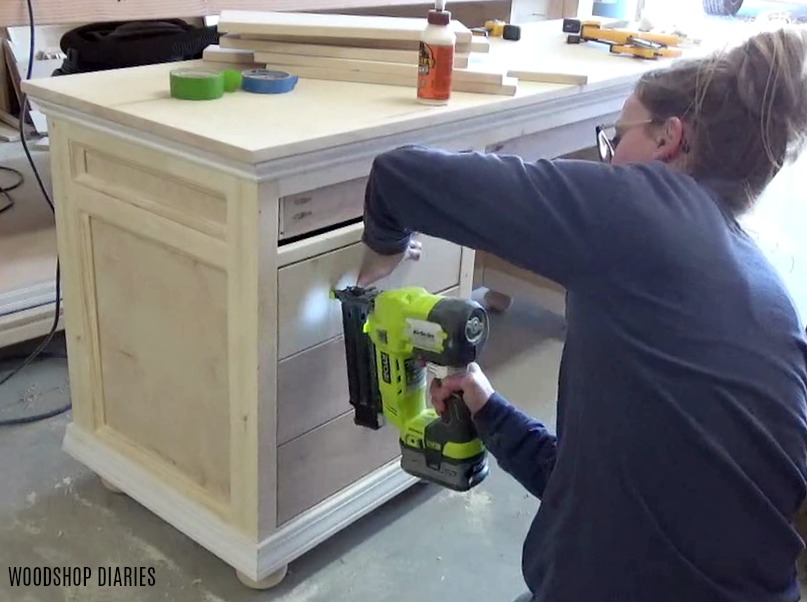 Nailing drawer fronts in place onto DIY storage desk