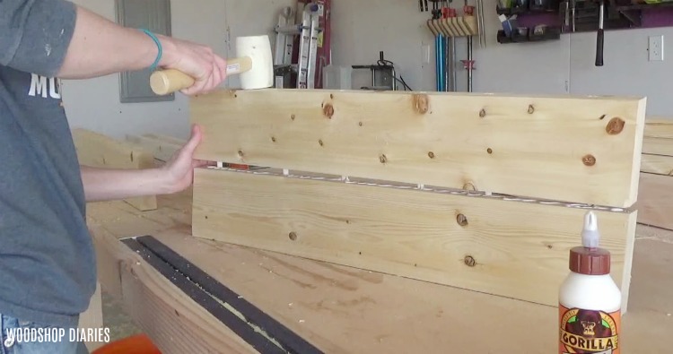 Joining two boards together using dowels and tapping into place with rubber mallet