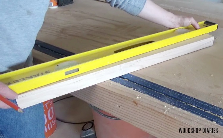 marking a tapering line on piece of wood with a level