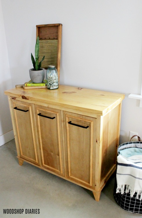 Finished DIY tilt out laundry hamper cabinet stained with summer oak