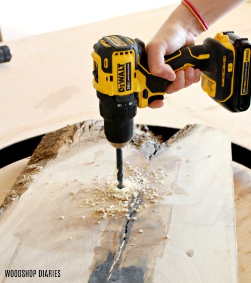 Using drill to drill a hole into wood