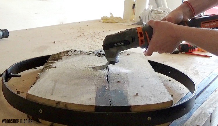 Oscillating saw used to cut out back of clock