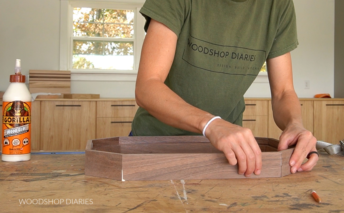 Shara Woodshop Diaries applying glue to tray sides on workbench