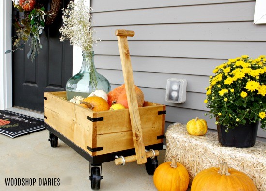 Display pumpkins in wooden wagon for a fun fall front porch idea