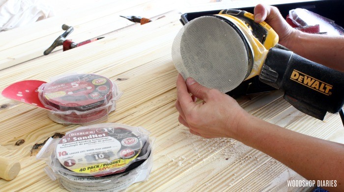 Sticking 220 grit sandpaper onto orbital sander