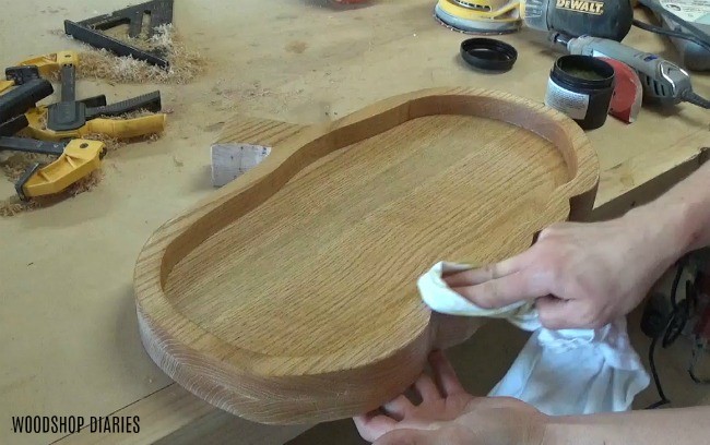 Applying stain to wood pumpkin shaped tray.