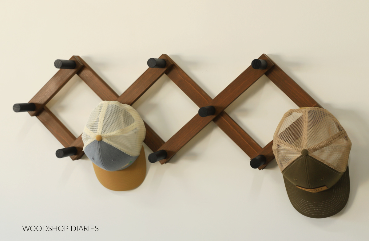 DIY wooden accordion hat rack with wooden rack and black pegs