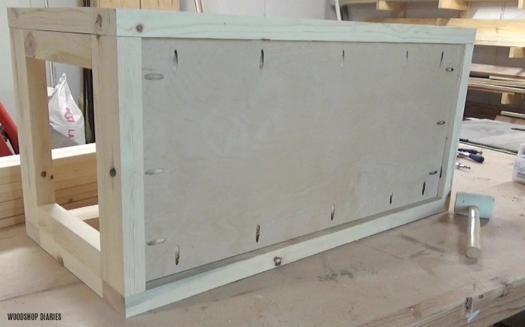 Plywood bottom installed using pocket holes and screws into 2x4 wooden storage trunk/hope chest frame