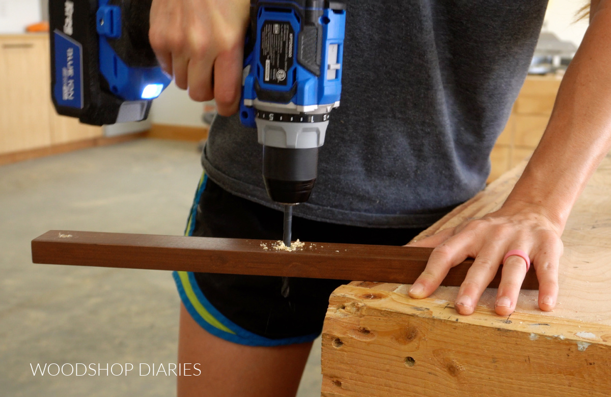 Close up of drilling holes for back pieces of accordion hat rack