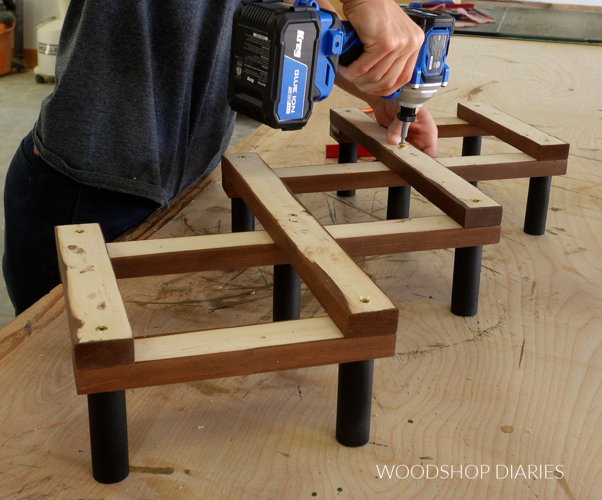 Shara Woodshop Diaries installing screw in center hat rack board