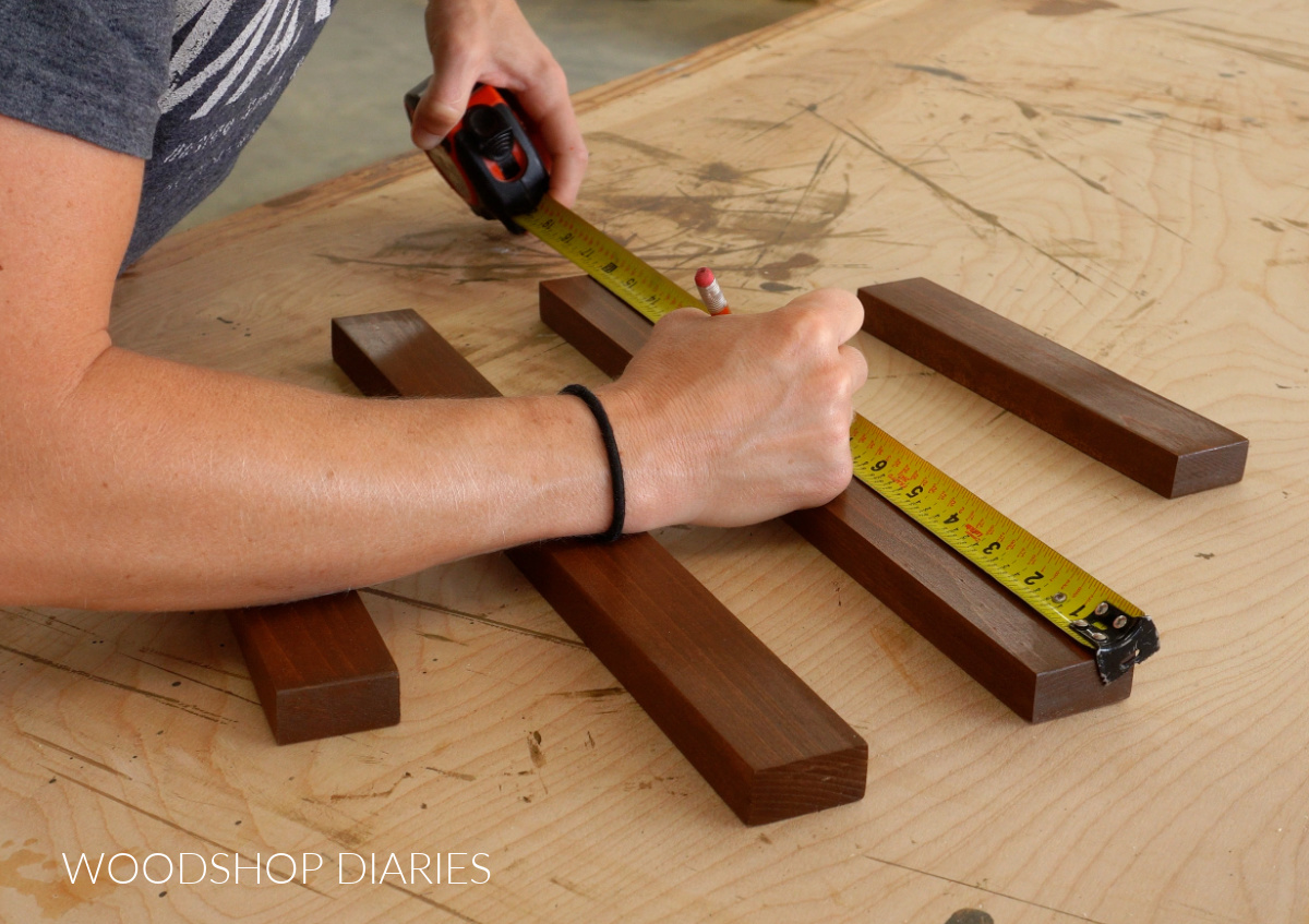 Shara Woodshop Diaries marking peg locations on hat rack boards