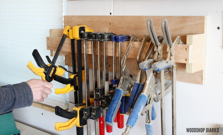 Close up of hanging clamps on DIY clamp rack