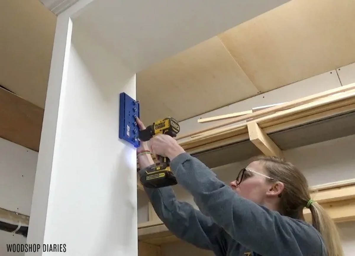 Drill shelf pin holes into DIY entertainment center cabinet