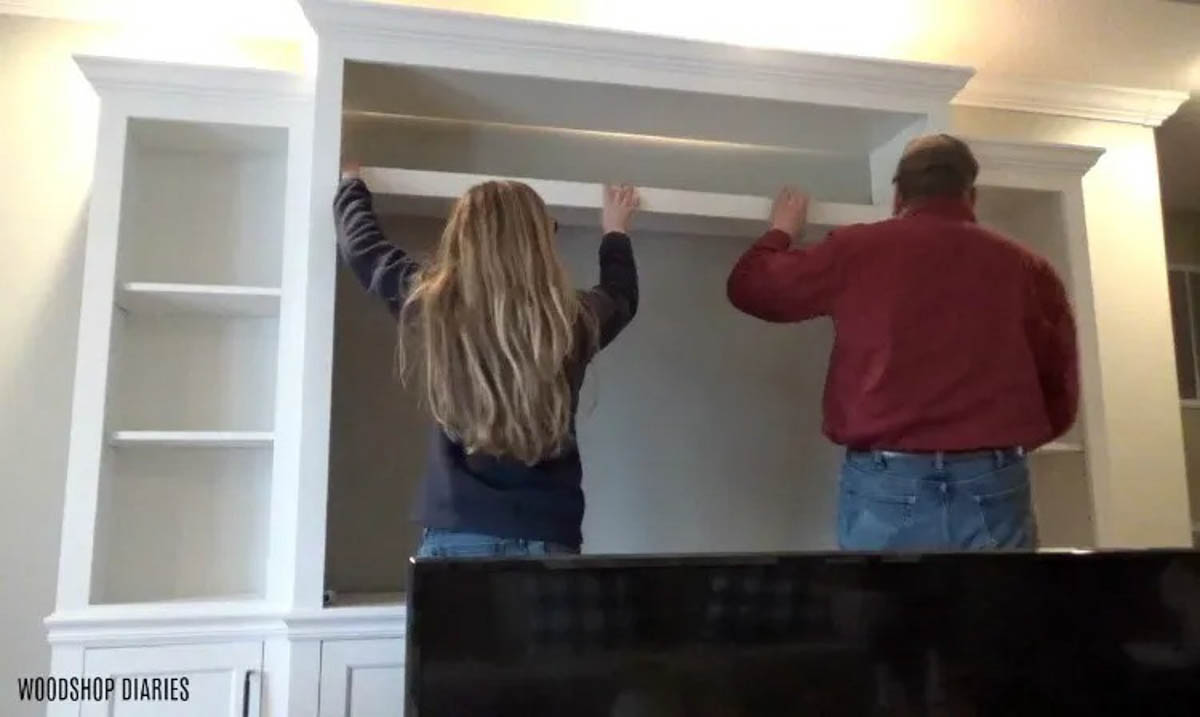 Shara and Dad installing shelves into Entertainment center