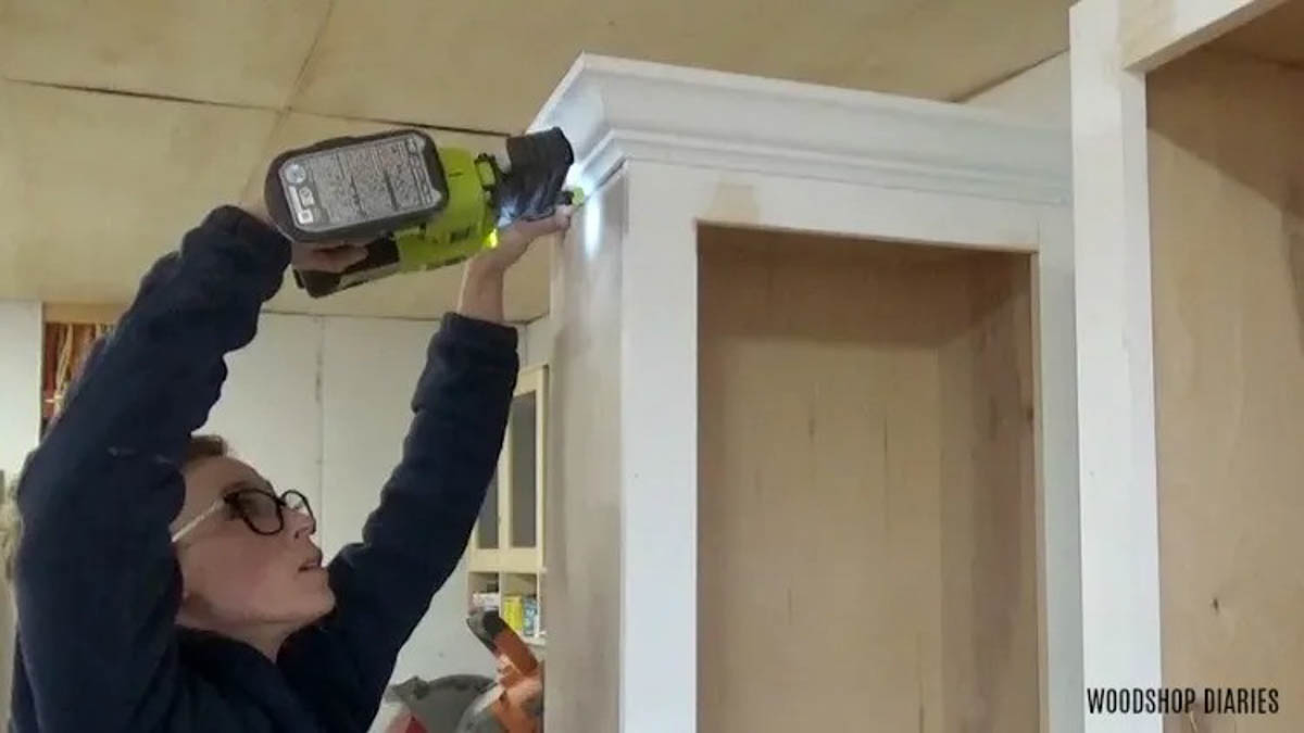 nail crown molding onto top of side cabinets of entertainment center