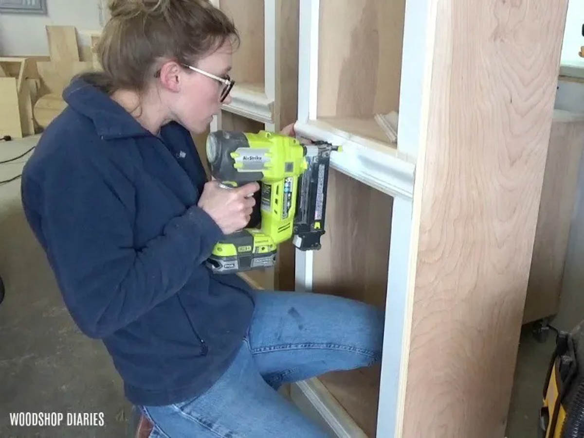 Nail chair rail molding onto side cabinets of DIY entertainment center