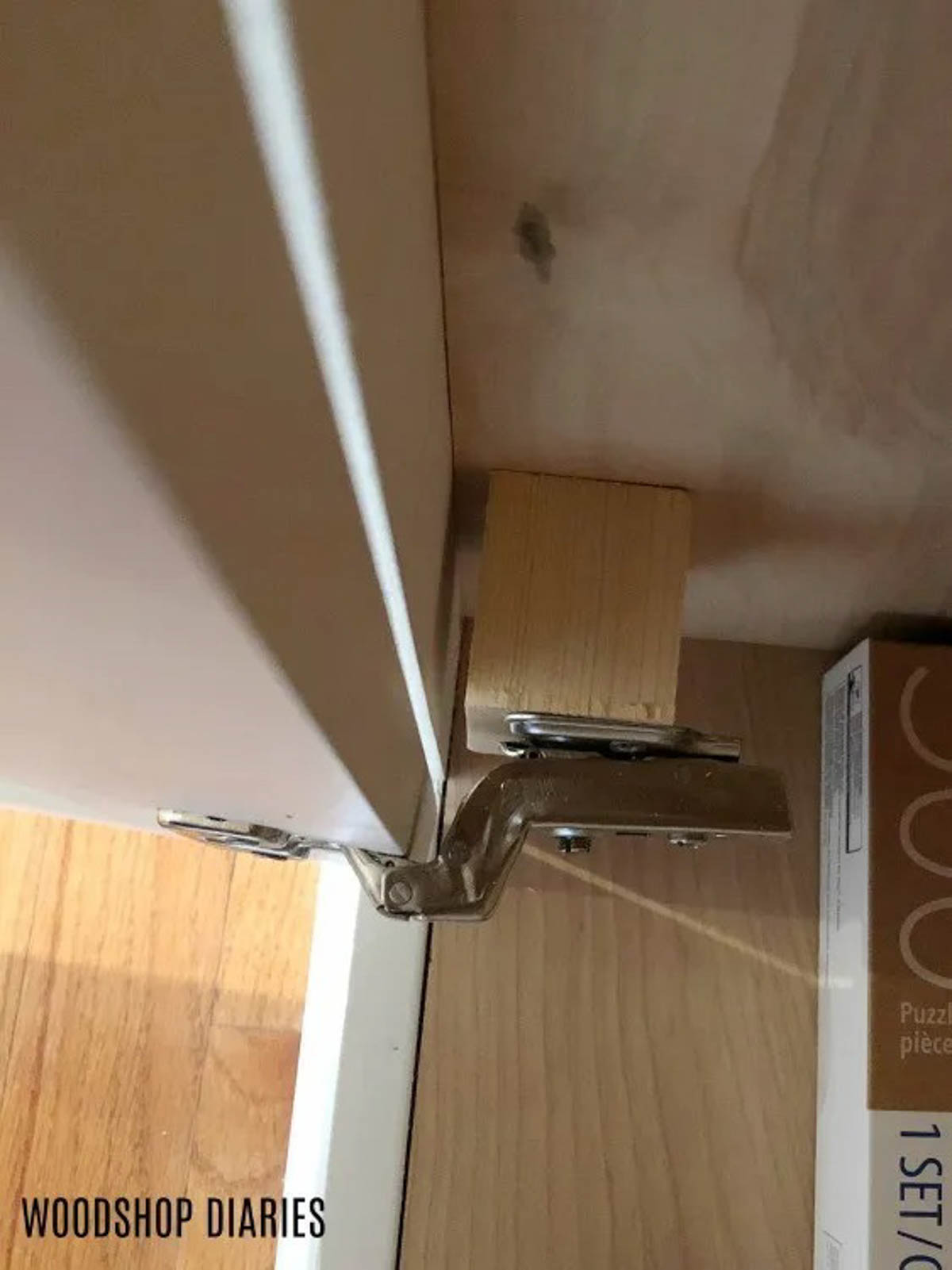 close up image of spacer block being used to install door hinges