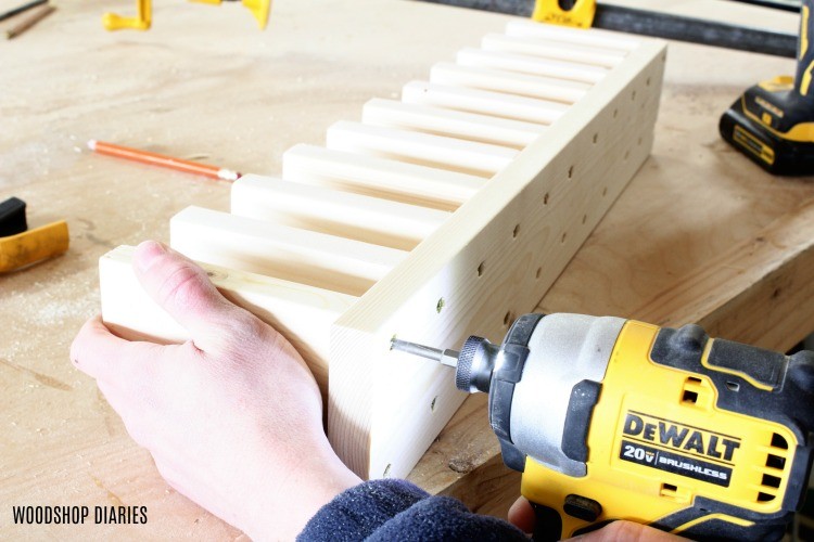 drive last screw to attach clamp rack divider blocks