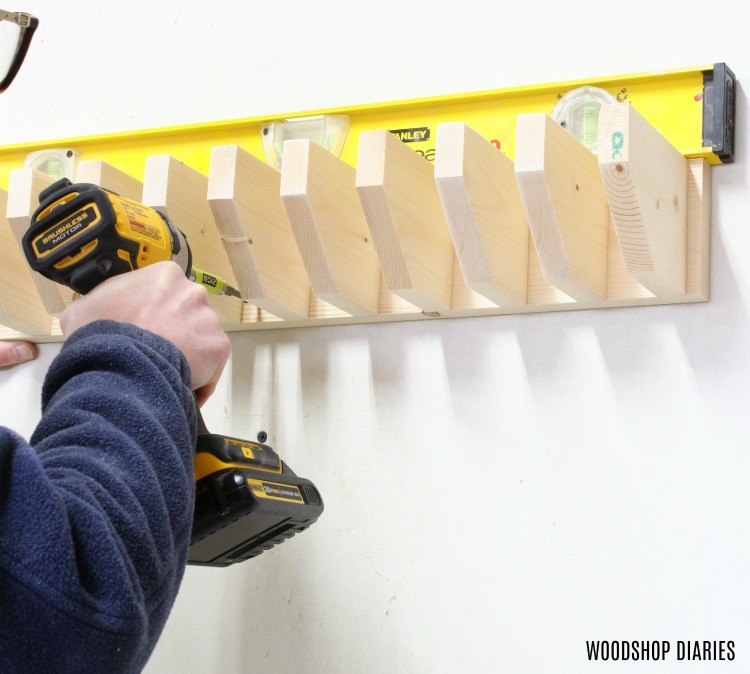 Screwing DIY Pipe Clamp Rack into Studs in shop wall