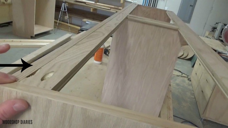 Edge banding applied along top edge of entire cabinet body