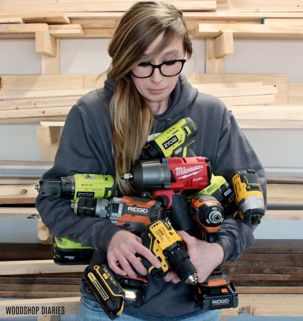 Shara Woodshop Diaries holding armful of drill, driver, and impact wrench