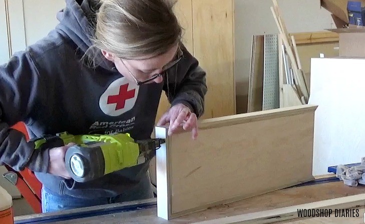 Brad nailing lip around wall shelves to prevent items from rolling off