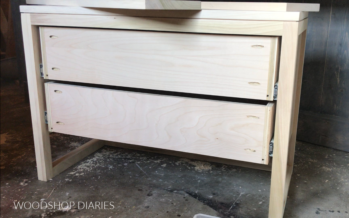 Drawer boxes installed on slides of DIY modern nightstand frame