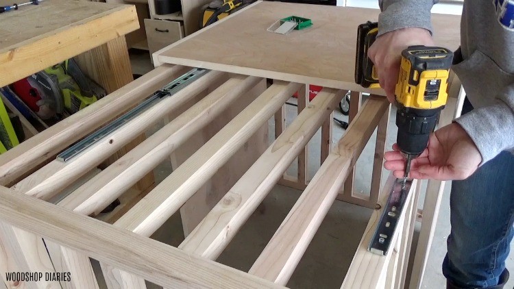 Screwing drawer slides into dog crate slats