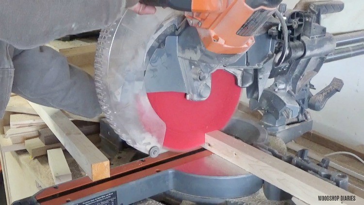 Trimming boards with miter saw to length to assemble floating shelf frame