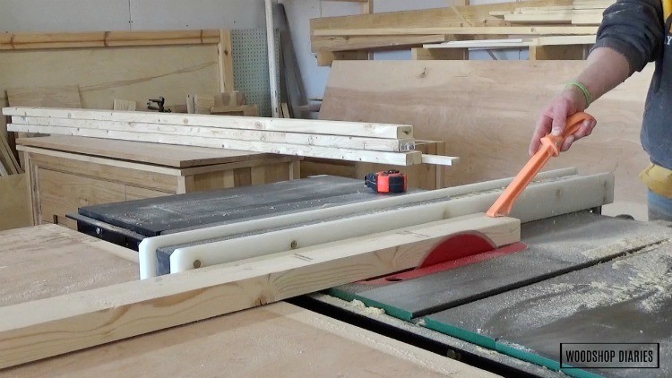 Running edge of 2x4 through table saw to clean up and square off edges