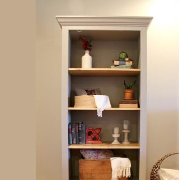 free standing bookshelf with decor displayed on shelves