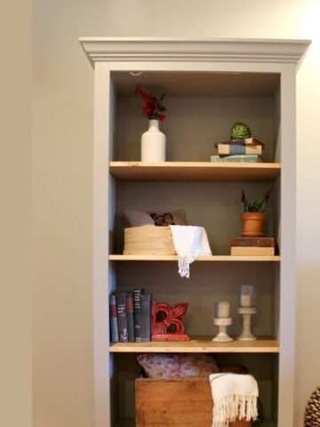 free standing bookshelf with decor displayed on shelves