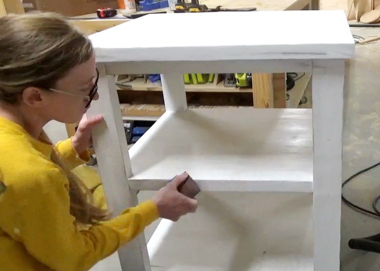 Sanding corners of shelves to give it a farmhouse distressed look